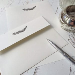 Writing paper with a Feather illustration