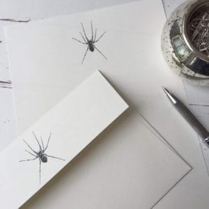 Writing paper with a Spider illustration